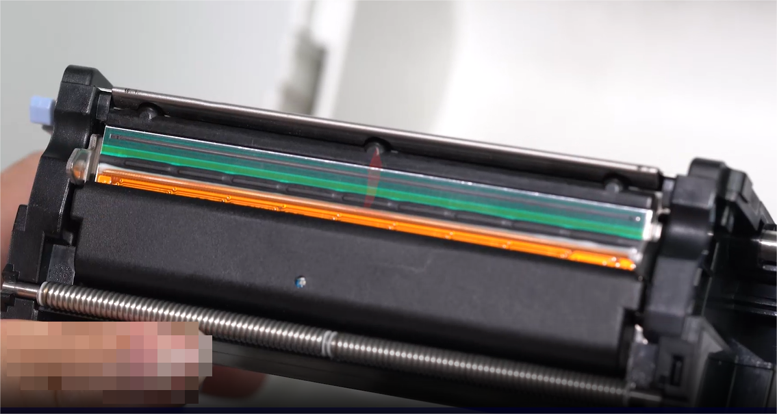 ألف close-up of a person carefully cleaning an electronic component with a swab.
